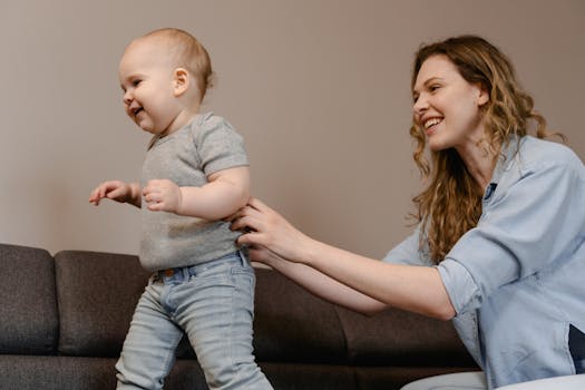 parent helping toddler with potty