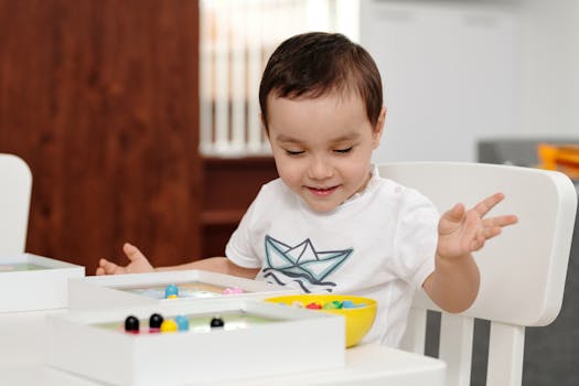 happy toddler sitting on potty chair