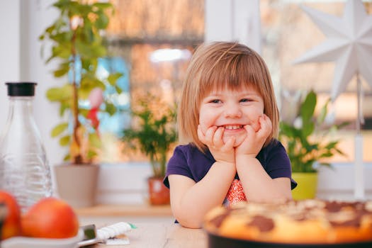 a toddler smiling next to a potty